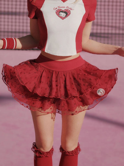 Person wearing a red and white outfit with a heart design on a pink background