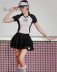 Model wearing the Betty Boop Tennis Tee – White & Paris Black with the Betty Boop Cake Skirt – Paris Black on court.