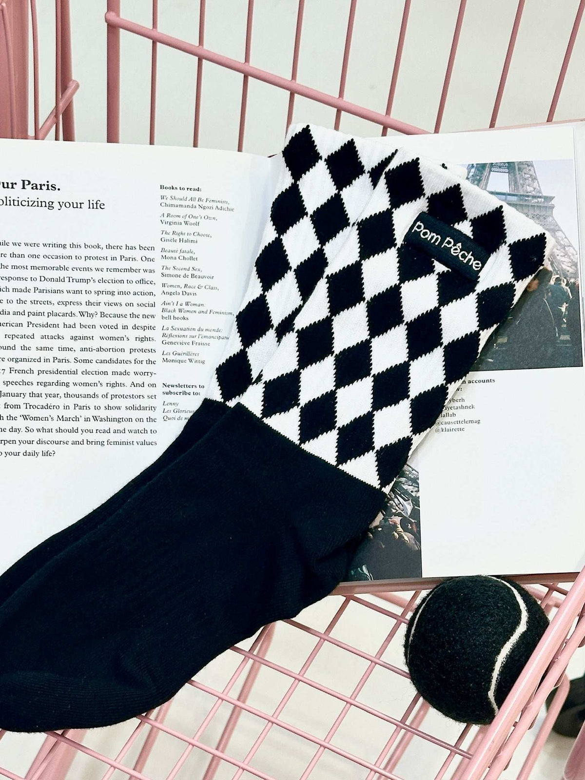 Black mid-crew socks with checkered pattern and Pom Pêche logo.