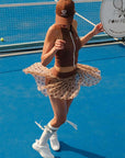 Brown zip-front tennis tank with a collar and subtle logo, offering a chic look for on-court wear.