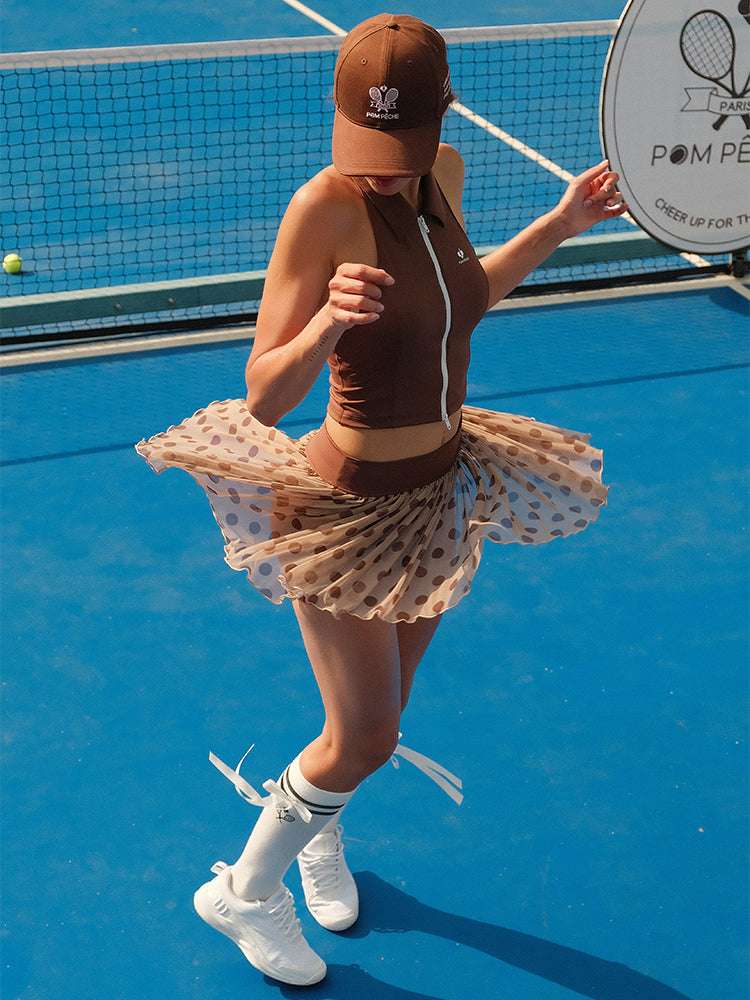 Brown zip-front tennis tank with a collar and subtle logo, offering a chic look for on-court wear.