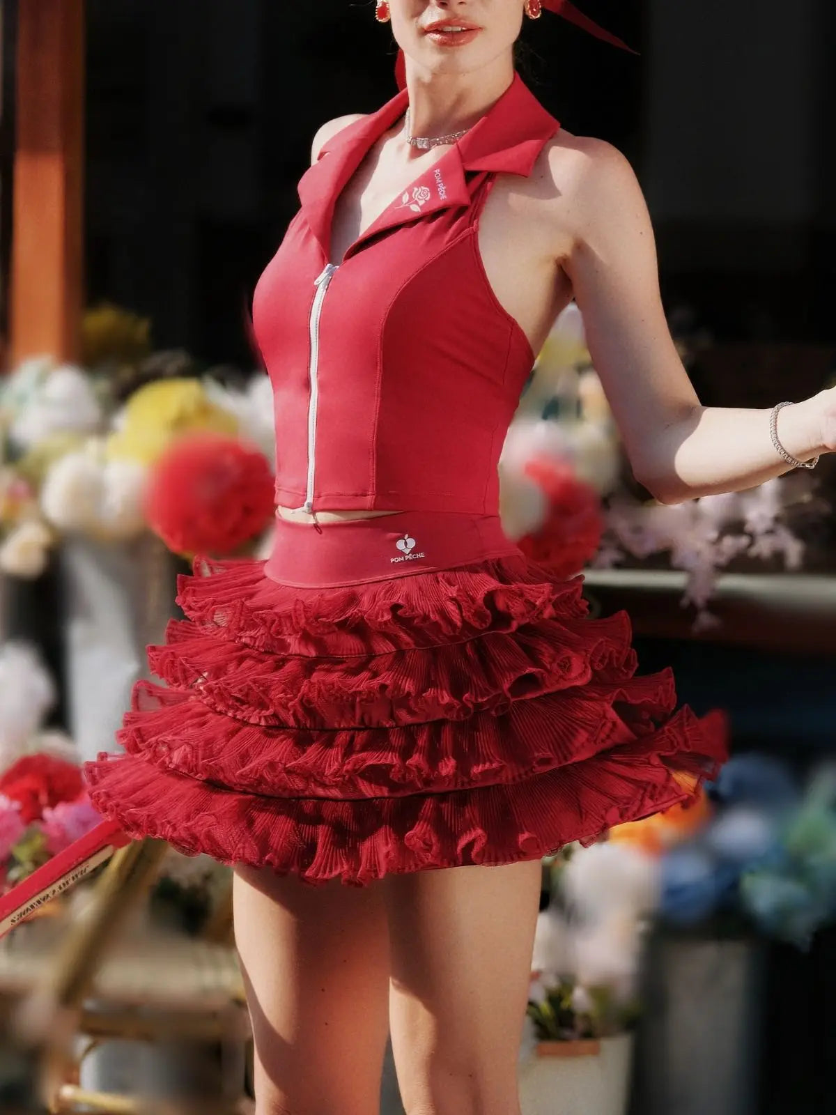 Woman wearing a red dress with a floral background