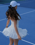 White ruffle tennis skirt with bow details, a soft layered look and airy movement.