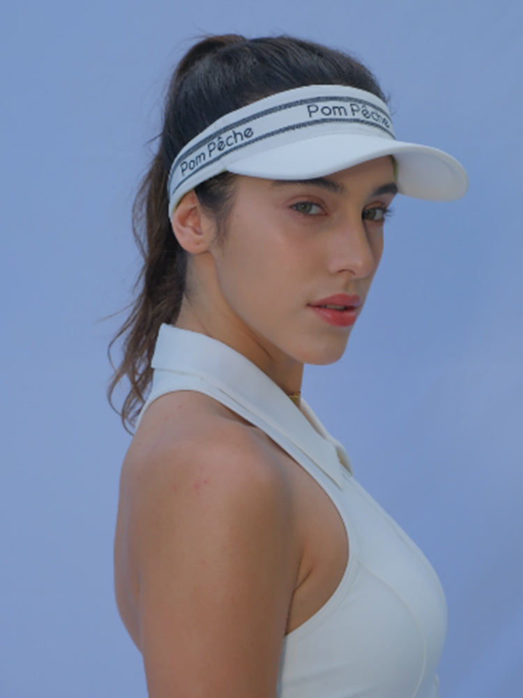 White tennis visor with a Pom Pêche logo on the band.