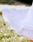 The White Spin™ rose petal dress features a four-layer mesh design, making it lightweight and flowy.