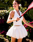 Outdoor display of models wearing the white Spin™ Rose Petal Skirt