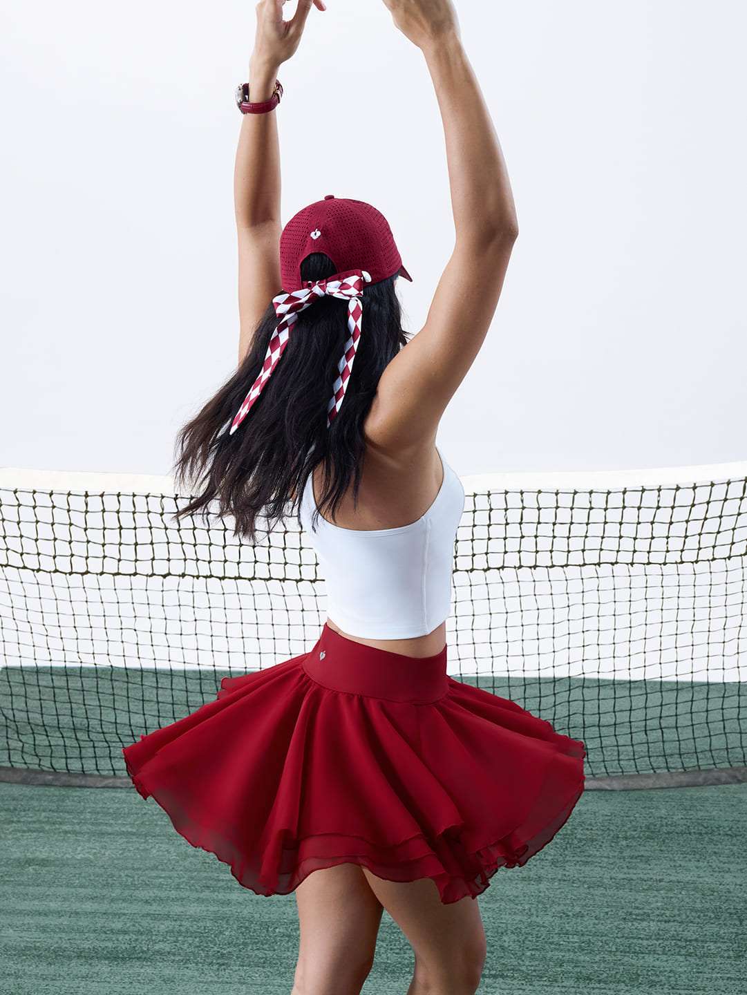 Burgundy ruffle pleated tennis skirt with mesh layers and wide flare for active court movement