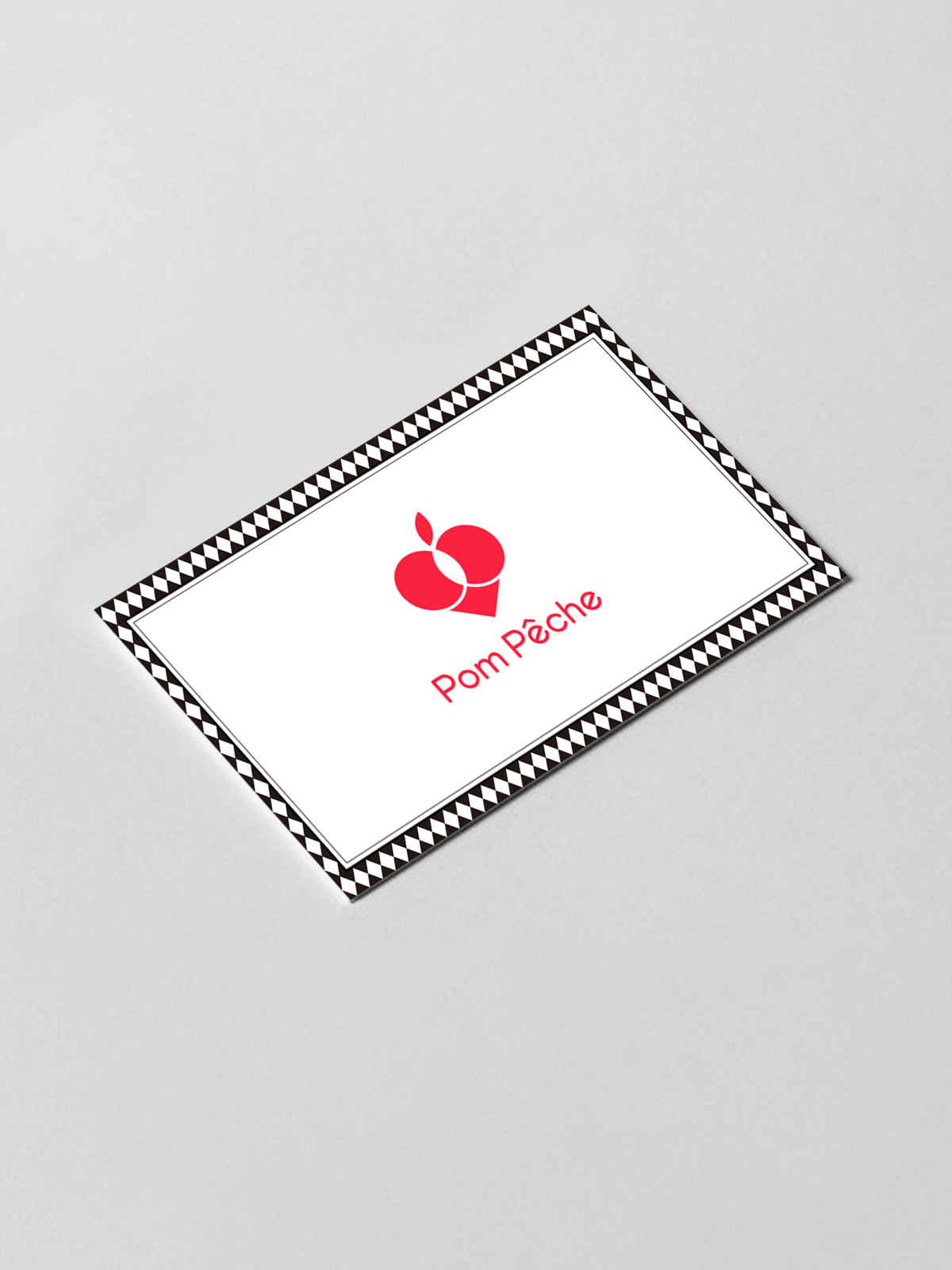 Rectangular white card with a red logo and 'Pom Pèche' text on a light gray background