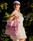 Oversized Court Tote Bag worn by a woman, showcasing spacious canvas tennis bag design, comfortable shoulder carry, and stylish sporty outfit