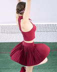 Person wearing a red outfit on a tennis court
