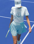 Person wearing a blue and white tennis outfit on a blue tennis court