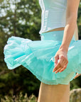 Spin Mesh Fairy Tennis Skirt Mint Green in Paris lifestyle scene, showcasing a flowy tulip hem tennis skort, built-in shorts, and elegant sporty movement