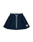 Flat lay of navy A-line tennis skirt with built-in shorts and elastic waistband.