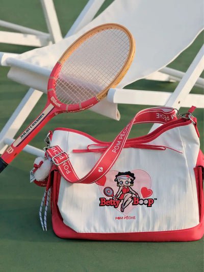 Tennis racket and bag with Betty Boop design on a tennis court