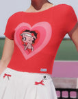 Red knit top with cartoon character in a heart design worn by a person.