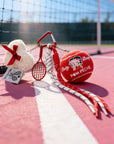 Tennis-themed keychain with a heart-shaped item on a tennis court