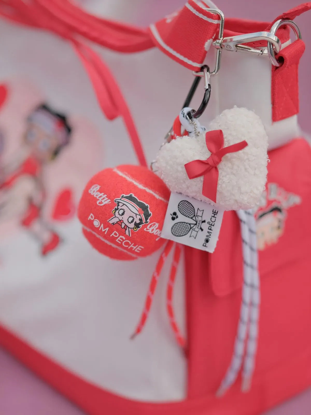 Pom-pom keychain with a tag on a red background