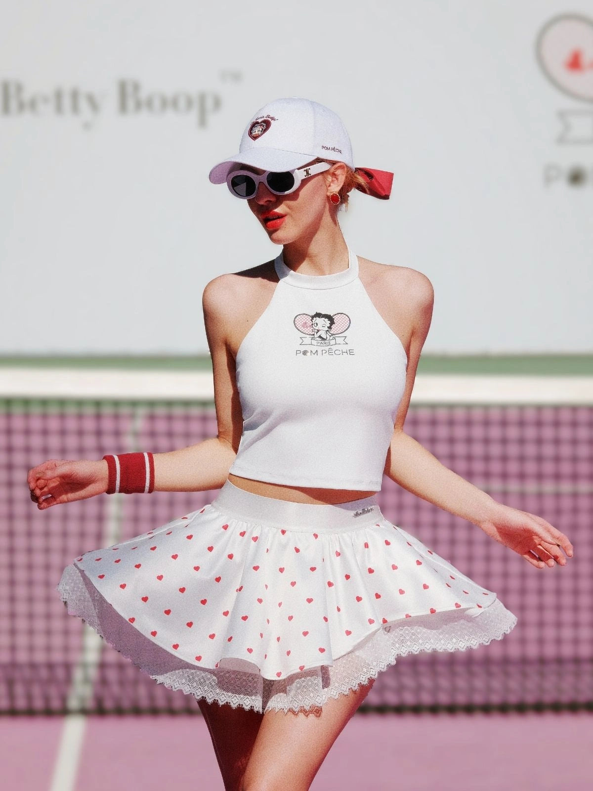 Model posing in Betty Boop Bow Halter Tennis Top - Paris White
