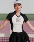 Woman wearing a black and white polo shirt with a logo on a sports court