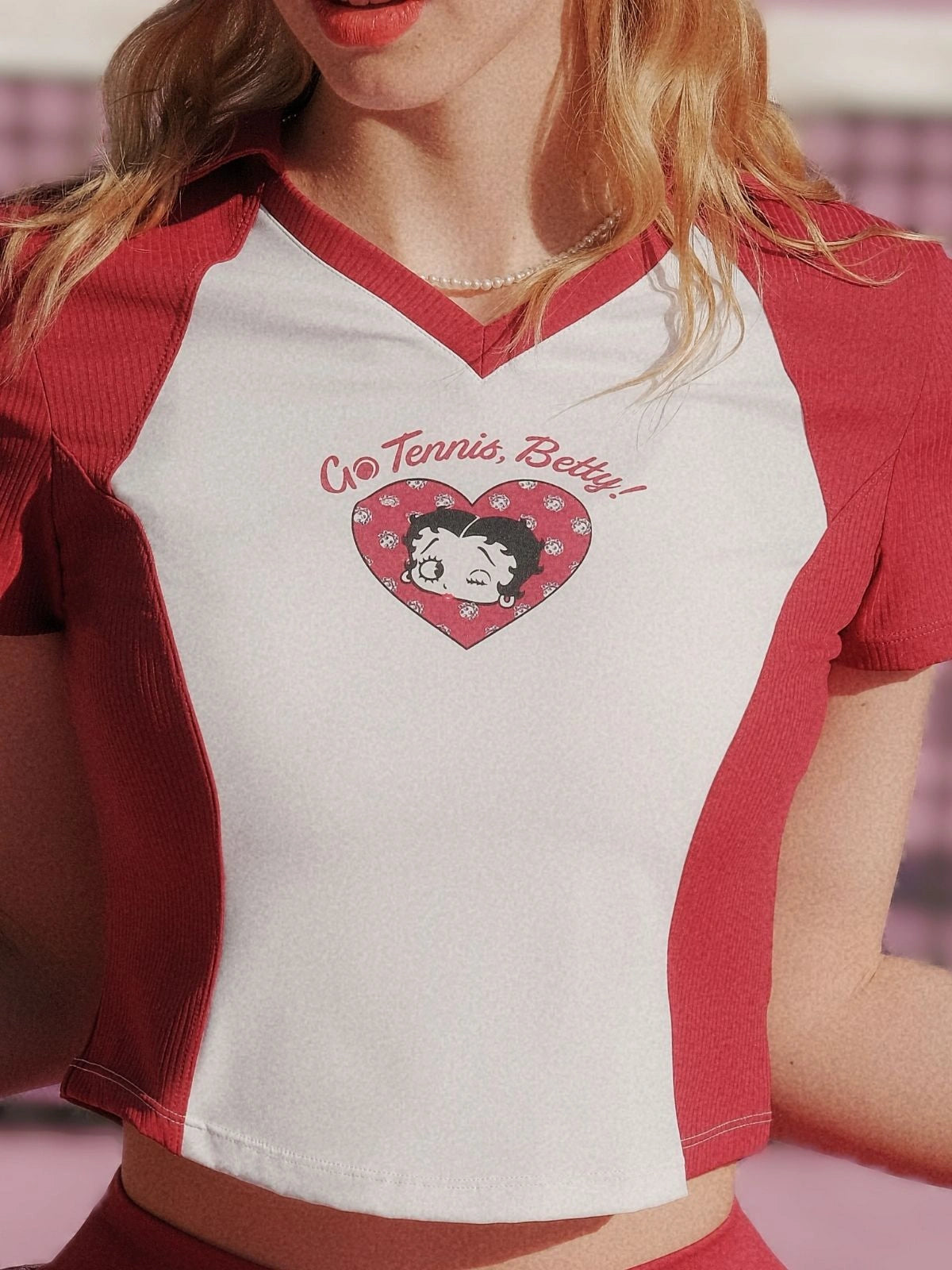 Red and white baseball-style shirt with graphic design and text