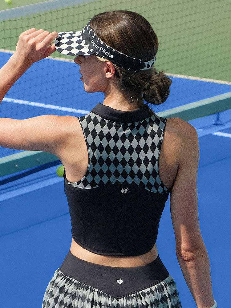 Black half-zip cropped tennis polo top with breathable mesh back and printed logo, designed for lightweight comfort on court.