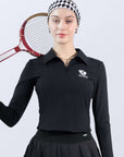 Black long-sleeve zip-collar polo top with a subtle printed logo, featuring a fitted silhouette for a sleek, sporty look.