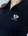 Black long-sleeve zip-collar polo top with a subtle printed logo, featuring a fitted silhouette for a sleek, sporty look.
