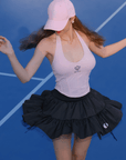 Black ruffle tennis skirt with bow details, a soft layered look and airy movement.