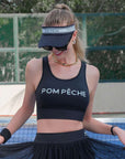 Black tennis visor with a Pom Pêche logo on the band.