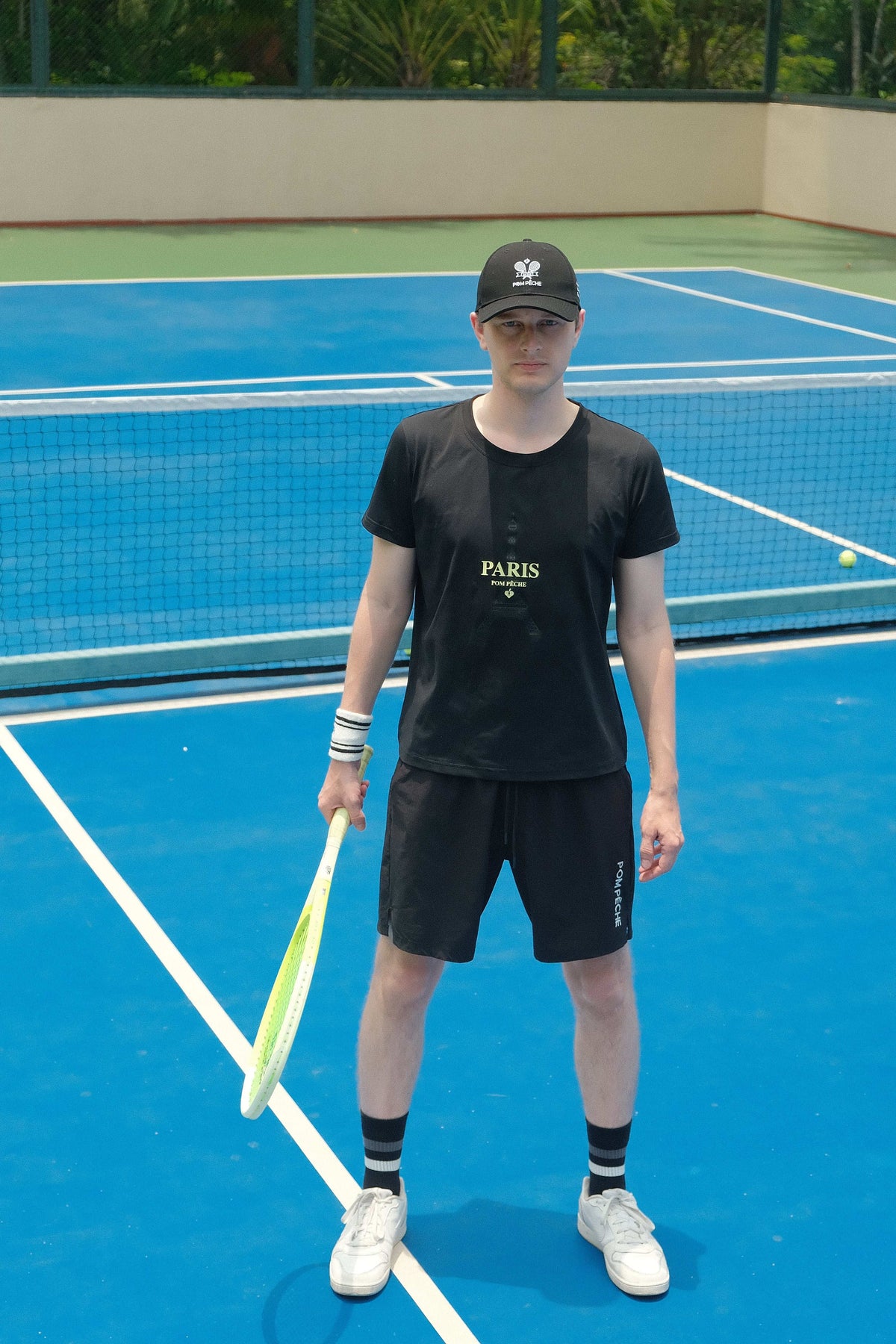 Black sports tee with a 'Paris' graphic and brand logo, designed for comfort and style during activities.