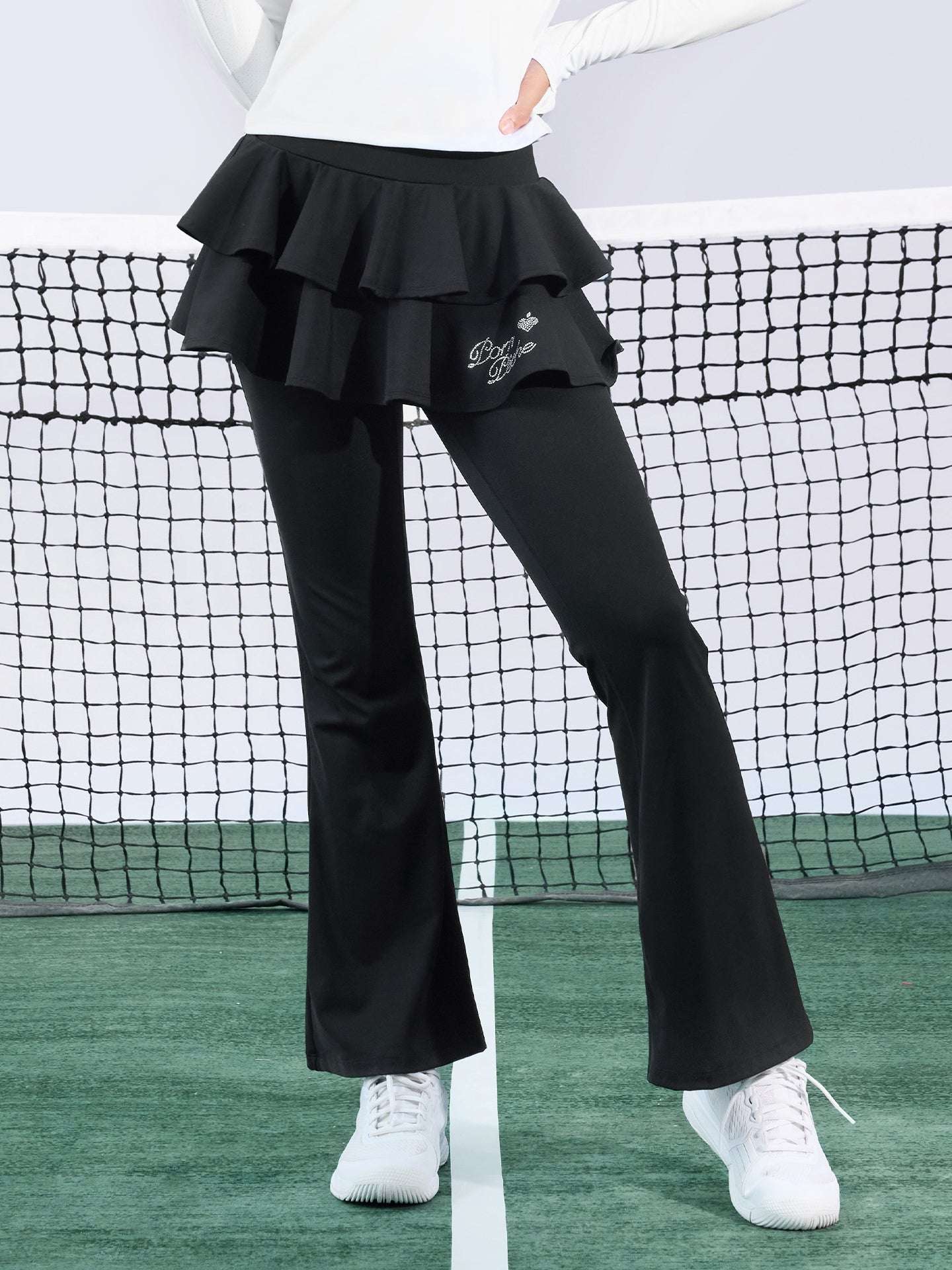 Black tiered-ruffle flare tennis leggings with built-in skirt, stretchy and breathable, easy movement from court to street.