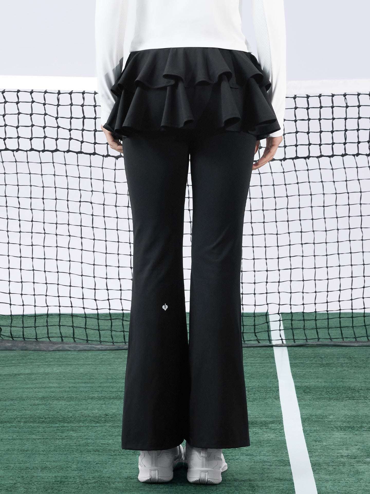 Black tiered-ruffle flare tennis leggings with built-in skirt, stretchy and breathable, easy movement from court to street.