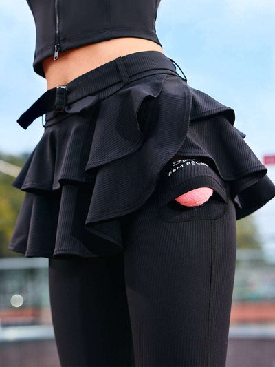 Black tennis leggings with a tiered ruffle skirt and high waist, stretchy fabric for comfort and active movement.