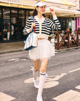Model walking the street in casual outfit. 