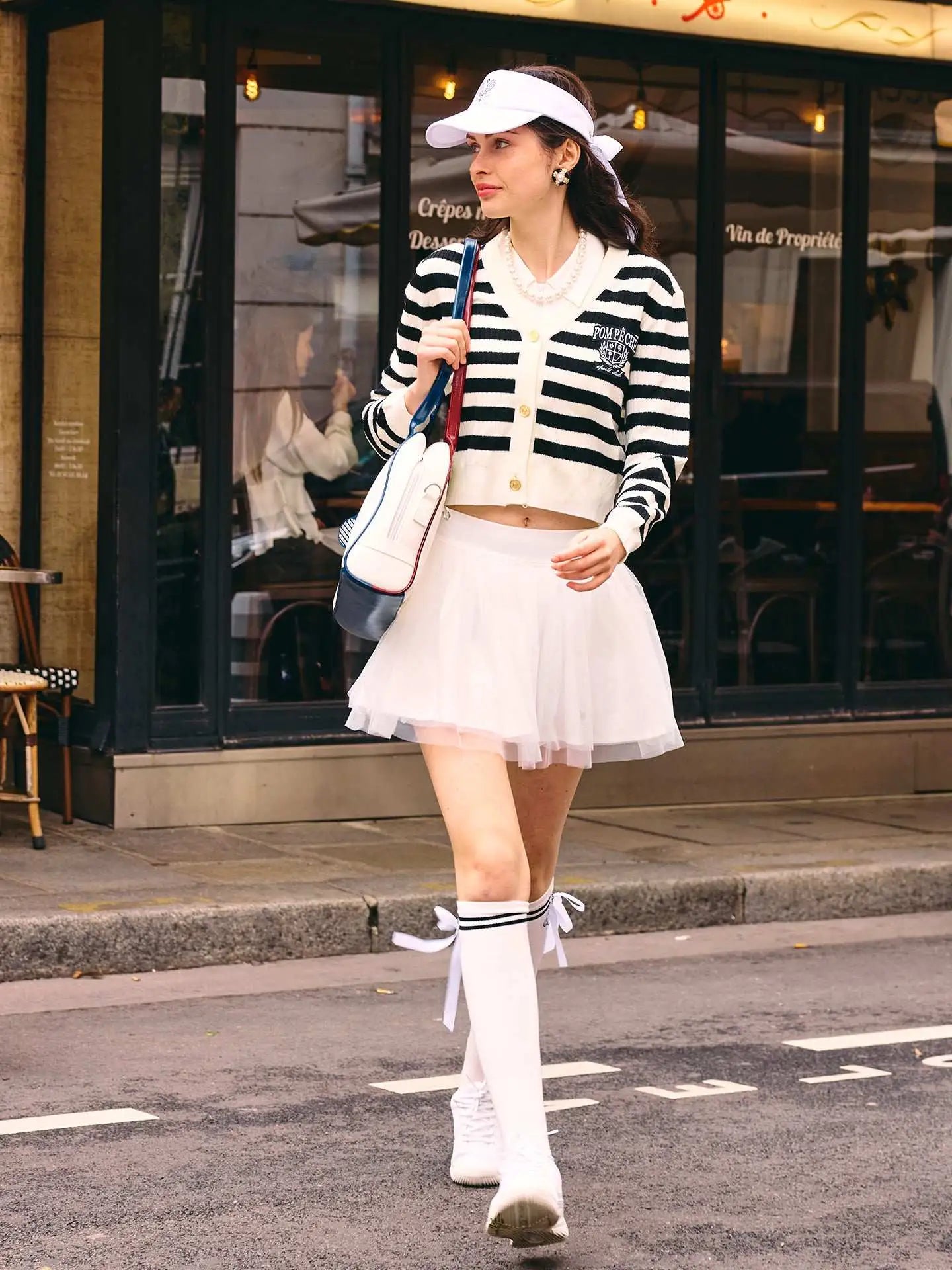 Model walking the street in casual outfit. 