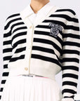 Model playin tennis wearing Pom Peche cardigan. 