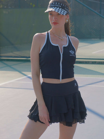 Black cropped zip-front tank top with contrast trim and subtle logo, designed for a sleek, sporty look on the court.