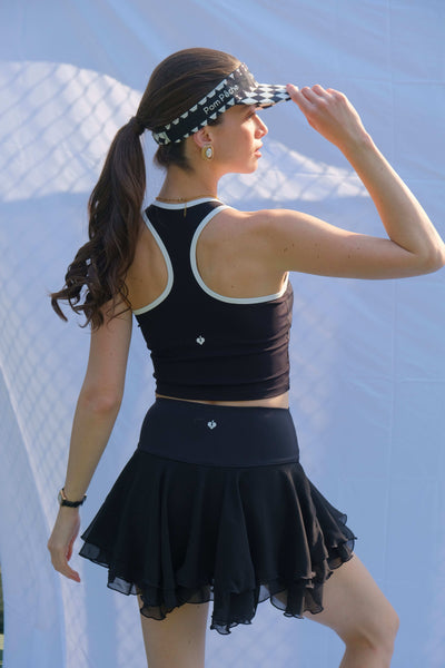 Black cropped zip-front tank top with contrast trim and subtle logo, designed for a sleek, sporty look on the court.