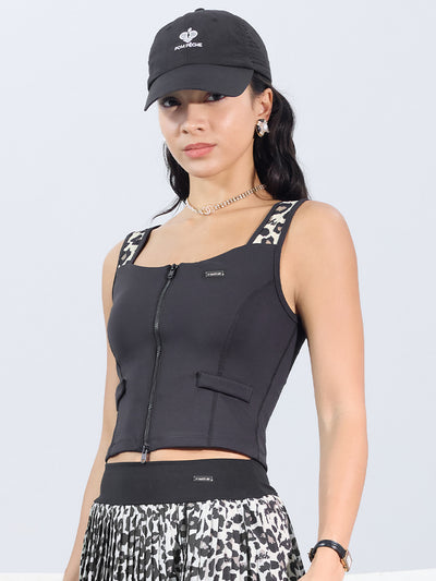 Leopard print sports tank with contrast straps and a zip front. Fitted, chic, and perfect for elevating your tennis practice look.