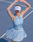Person in a blue tennis outfit on a tennis court