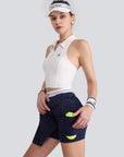 A classic navy pleated tennis skirt is featured as part of an athletic tennis apparel look