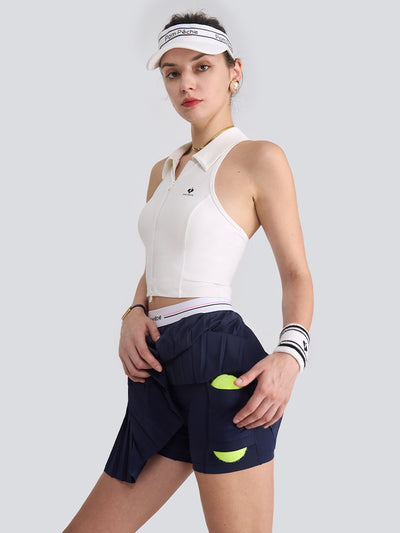 A classic navy pleated tennis skirt is featured as part of an athletic tennis apparel look