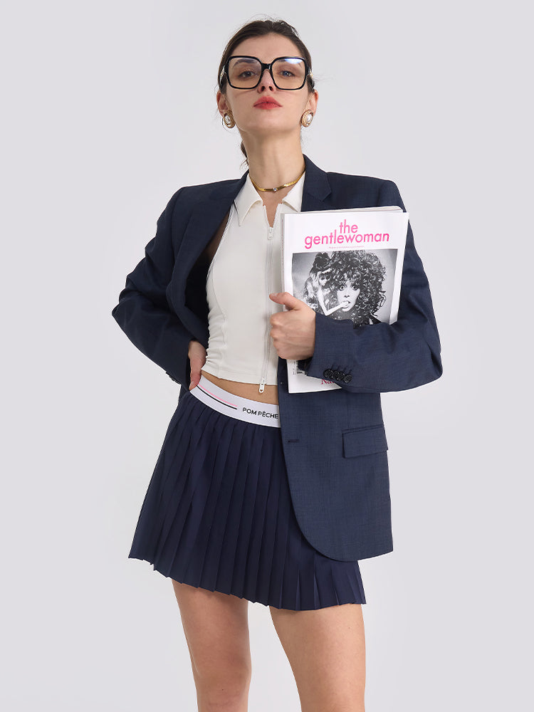 The model showcases a blue navy tennis skirt with pleated design for active movement and sport