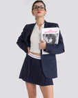 The model showcases a blue navy tennis skirt with pleated design for active movement and sport
