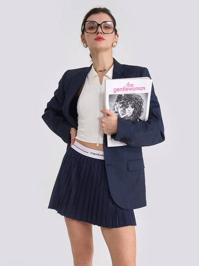 The model showcases a blue navy tennis skirt with pleated design for active movement and sport