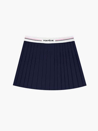  A navy pleated tennis skirt is displayed in a modern athletic outfit suitable for tennis or fitnes
