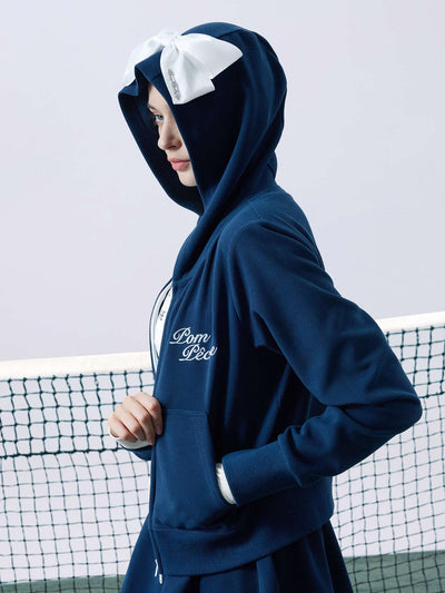 Navy blue zip-up hoodie with bow detail on the hood and embroidered logo, perfect for warm-ups or everyday wear.