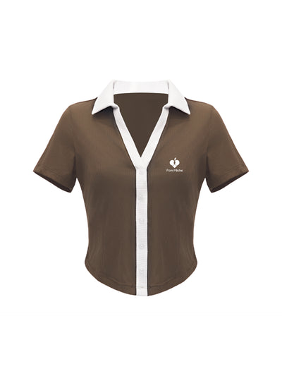 Brown cropped polo tennis top with button-up front and white trim, featuring a fitted, stretchy design for court or casual wear.