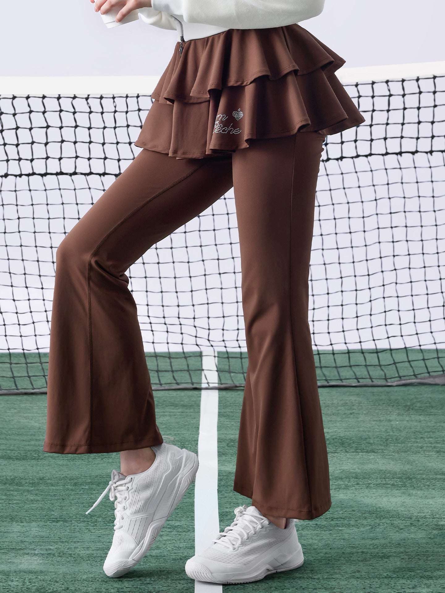 Brown flared tennis leggings with tiered-ruffle skirt, stretchy and breathable, easy movement from court to street.