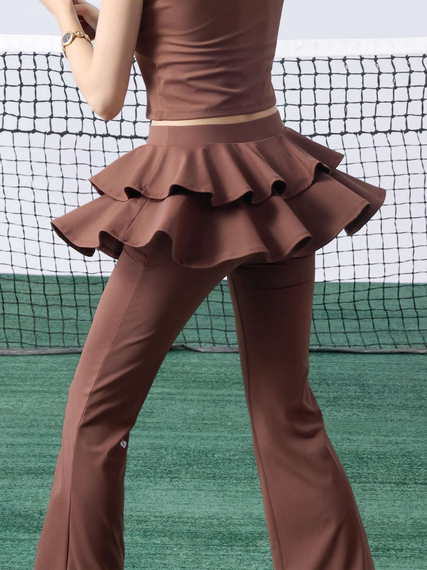 Brown flared tennis leggings with tiered-ruffle skirt, stretchy and breathable, easy movement from court to street.